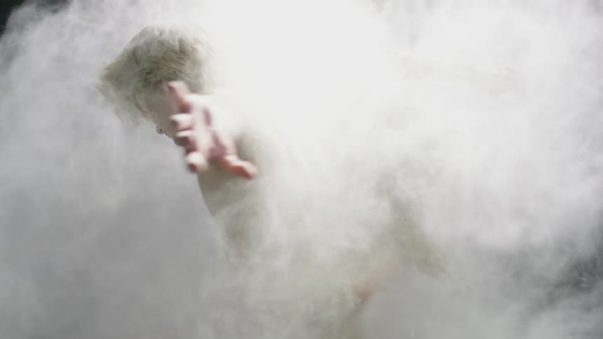 Two blonde dancers are covered in dust as they pirouette together
