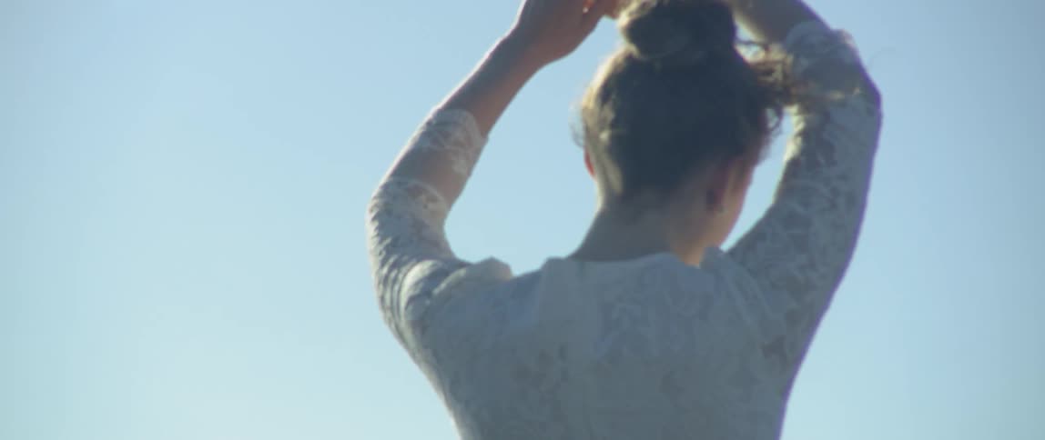 Woman spins like a ballerina under the sun