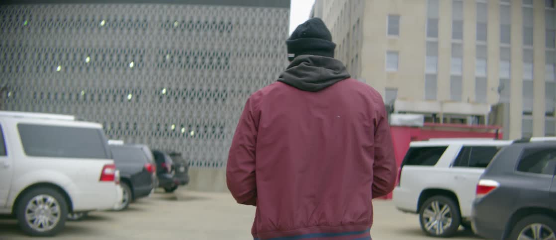 A man walks in the lot in the city