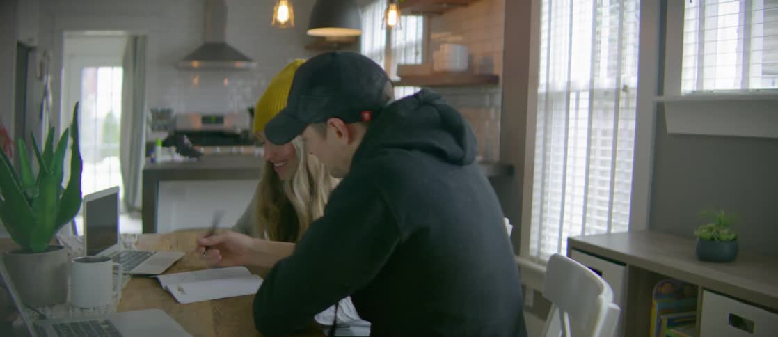 A man and woman talking while sitting at a table