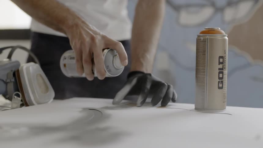A man spray painting a canvas