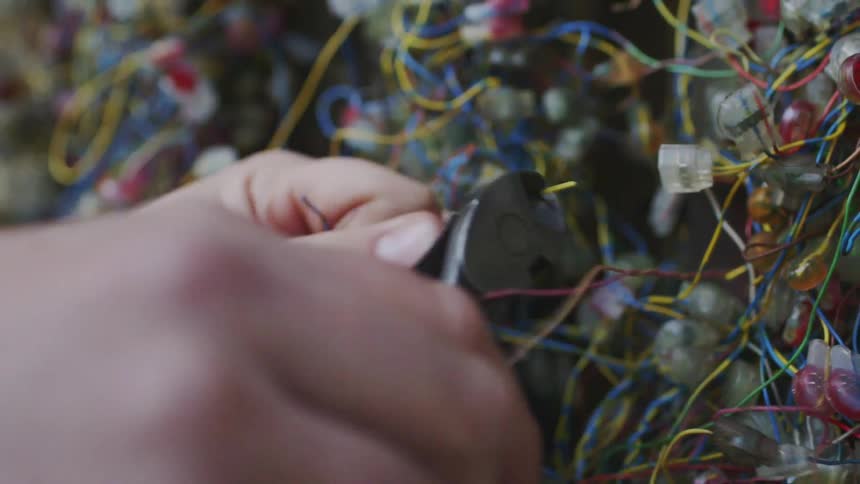 A person cutting wires