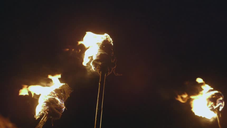 Burning torches against the night sky