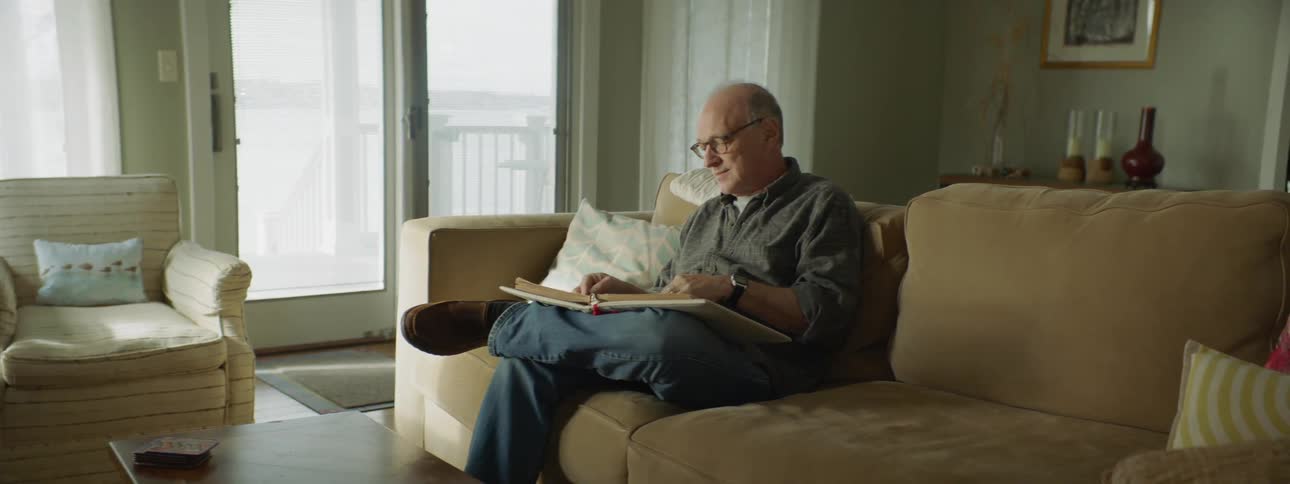A man is flipping through a photo album