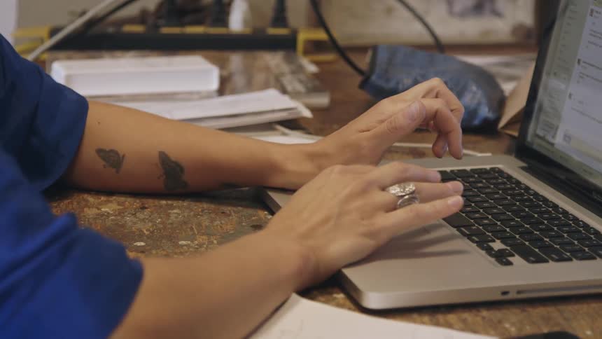A man typing on a laptop