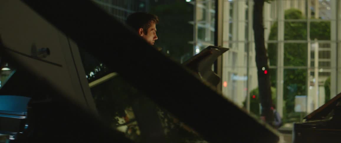 A man walks into a building that has a lot of pianos