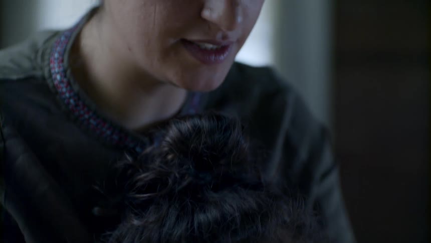 A child sleeping in a lap of a  woman