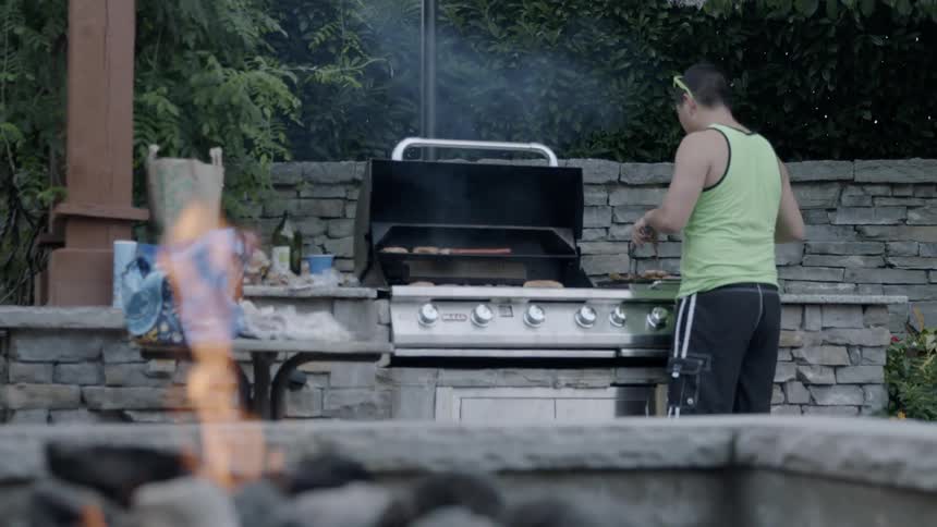 A person is grilling outdoors
