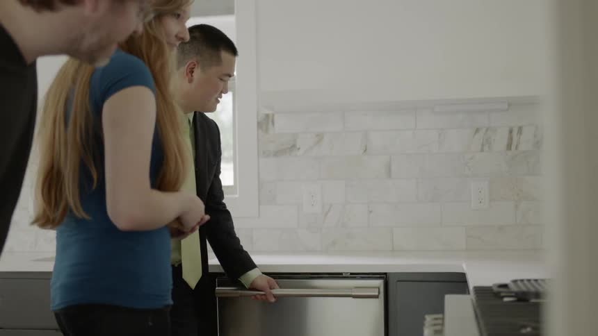A couple tour a home with a real estate agent
