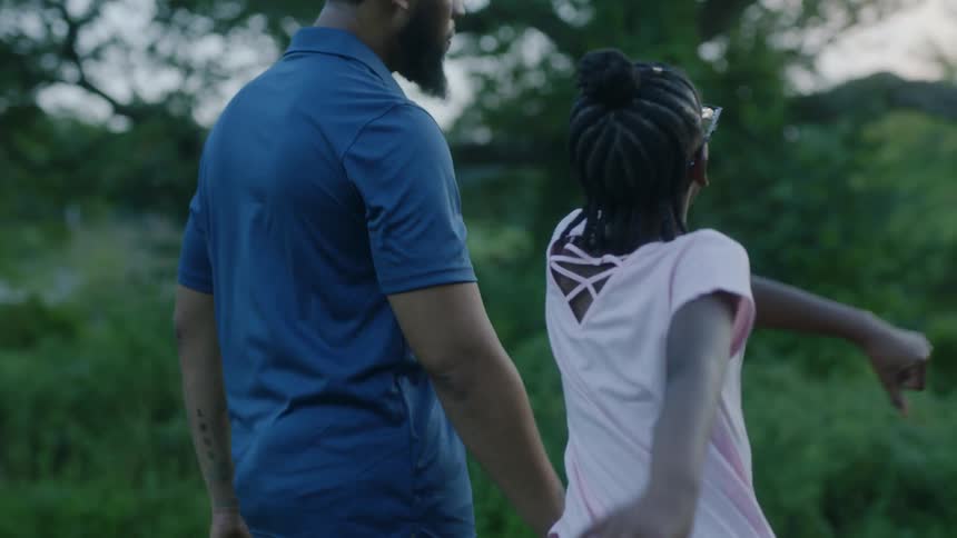 Father and child are walking outside together