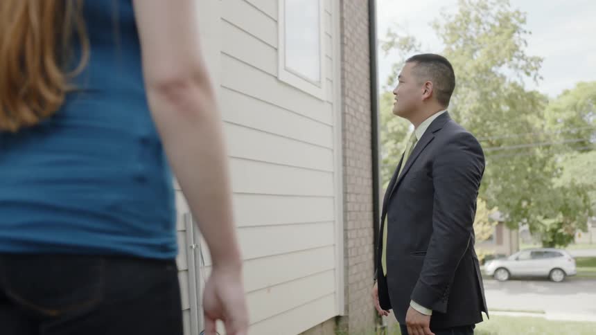 People are talking outside of a house