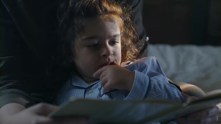 Mother is reading a book to her child