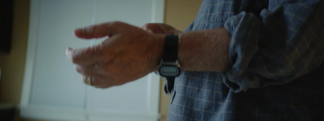 A man adjusts his watch