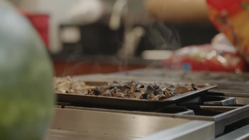 Food steaming on a tray on top of a stove