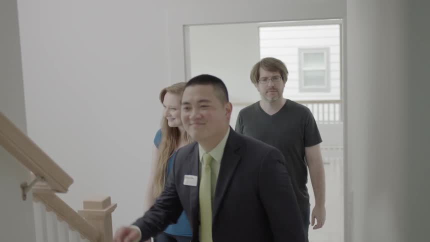 A man showing a house to a man and woman
