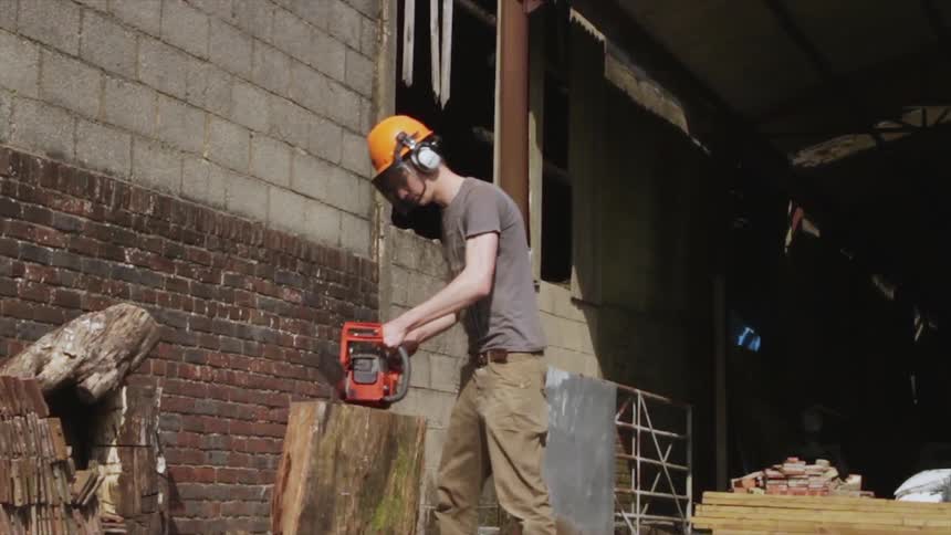 A person using a chainsaw