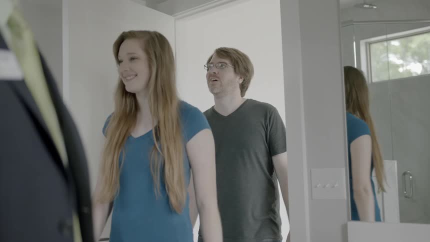 A man showing a bathroom to a woman and man