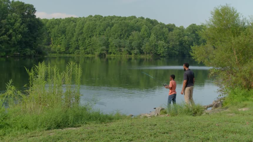 A father and son fish together in the lake