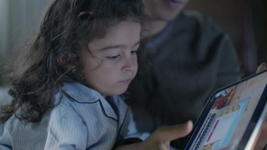 A woman and child browse with a tablet