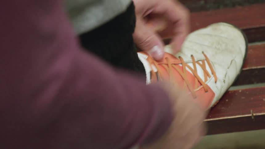 A person tying their shoes