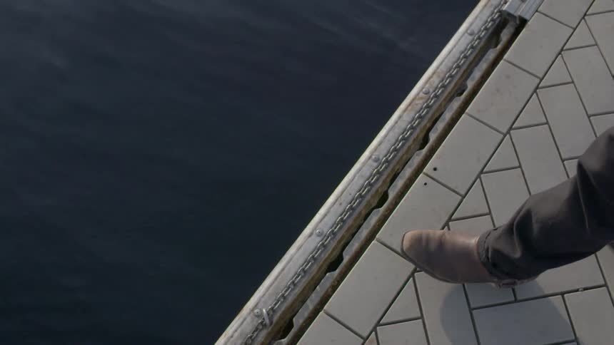 A person is walking off a ledge