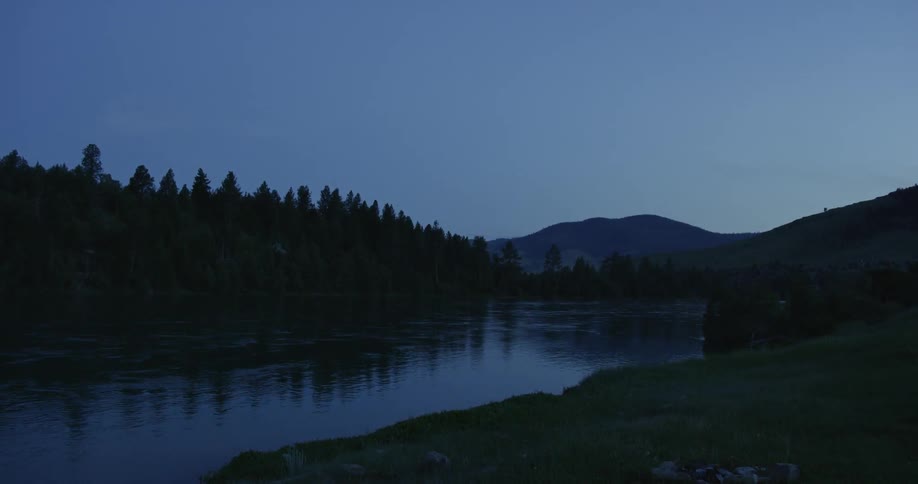 Water ripples on a forest river at dusk