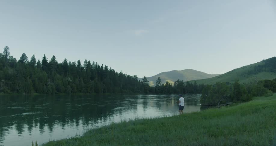 A man casting his fishing rod in to the lake