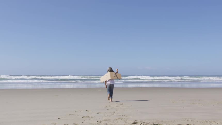 A child is running towards the ocean