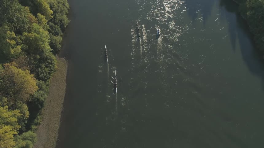 Row boats float on a river