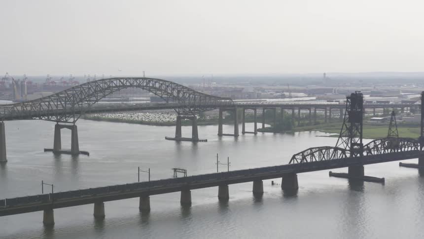 Aerial view of bridges over a river with city in background