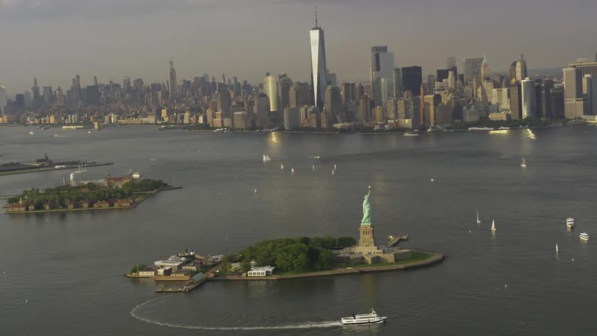 Statue of liberty in front of new york city skyline