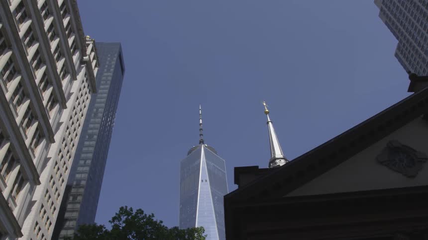 City skyscrapers tower overhead on a clear day