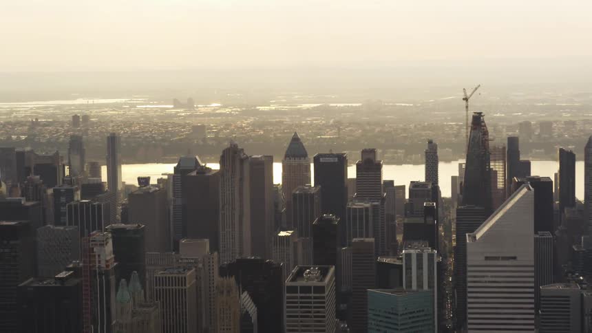 Tall skyscrapers and many buildings with a nearby river