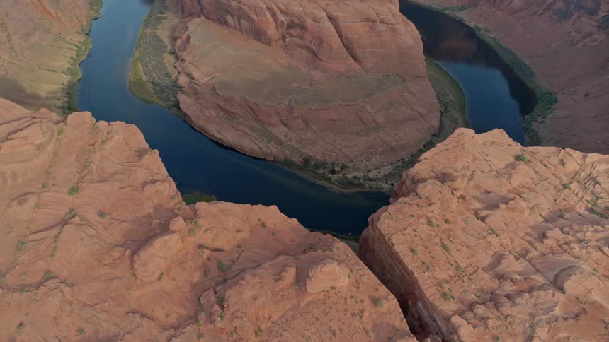 A red rock canyon with a river