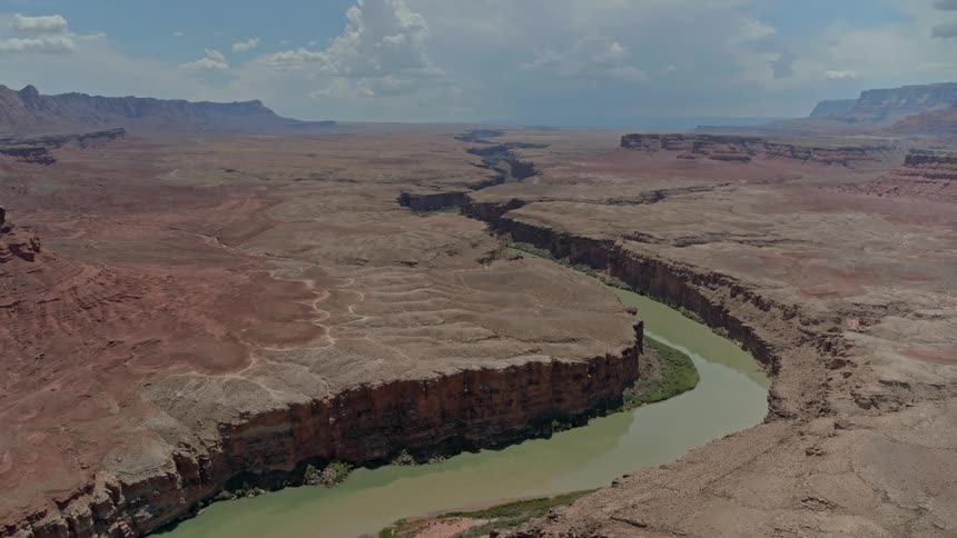 Deep canyon with green water surrounded by red rocks