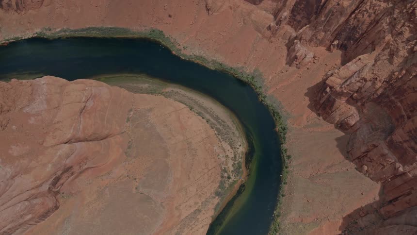 A river winds through a rugged desert canyon
