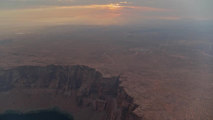 A pool of water sits next to the canyon