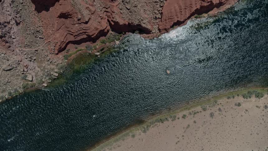 Red rocks and dirt with a river running through