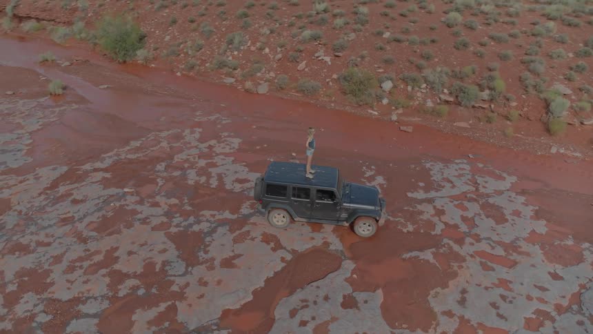 A person standing on a jeep