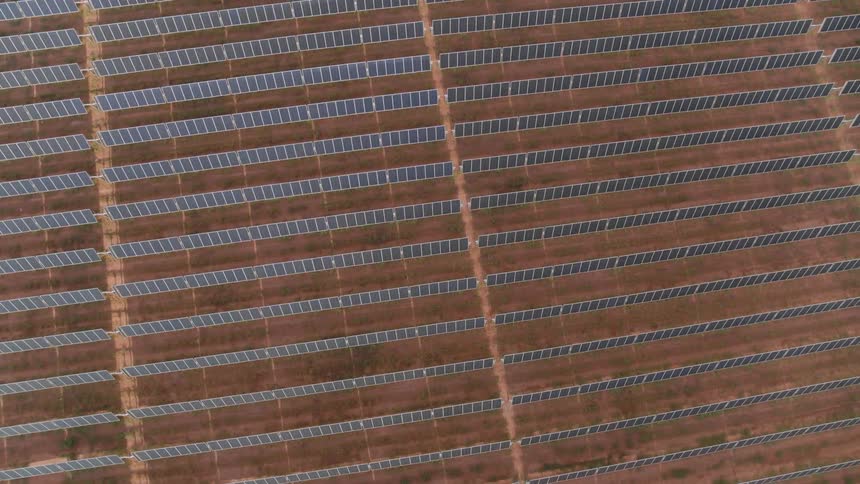 Solar panels in a solar farm all in rows and tilted