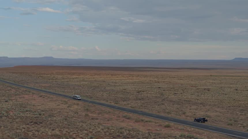 Cars travel on a rural road