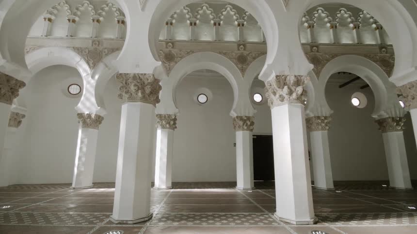 White pillars in a room with strong architectural designs