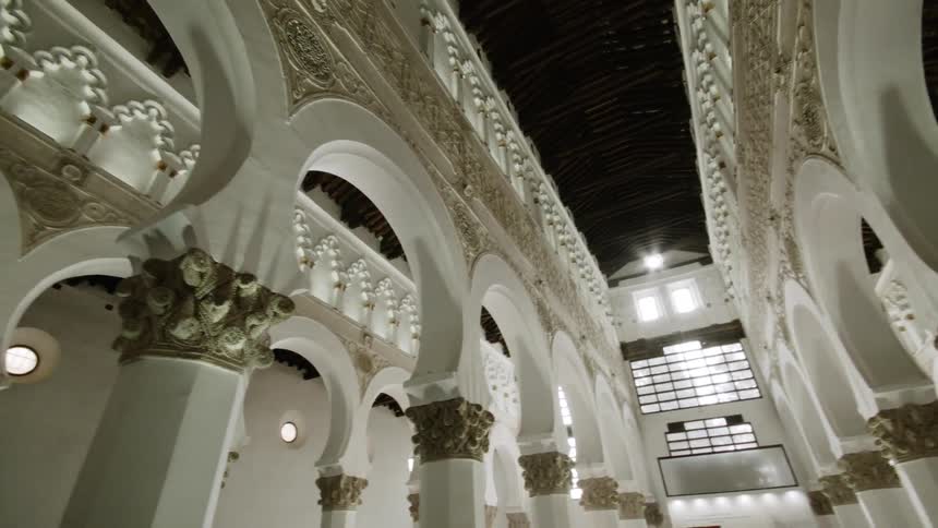 White pillars in a room with strong architectural designs