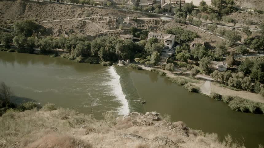 The river is running past the hills