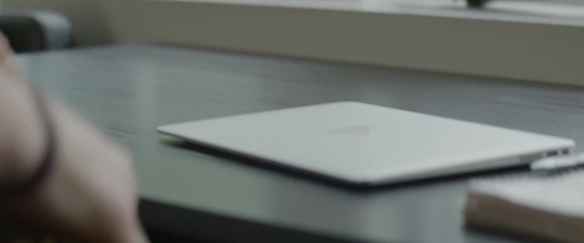 Man uses laptop and puts it in his bag by daytime