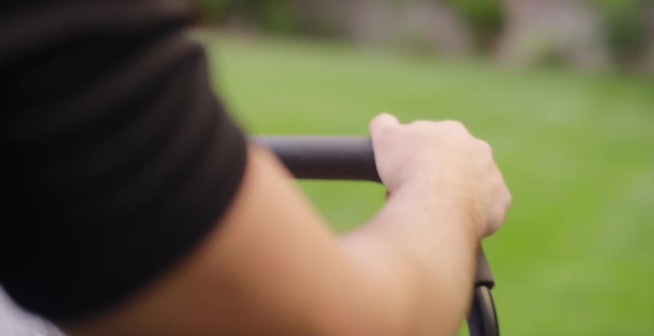 A person is riding a lawnmower