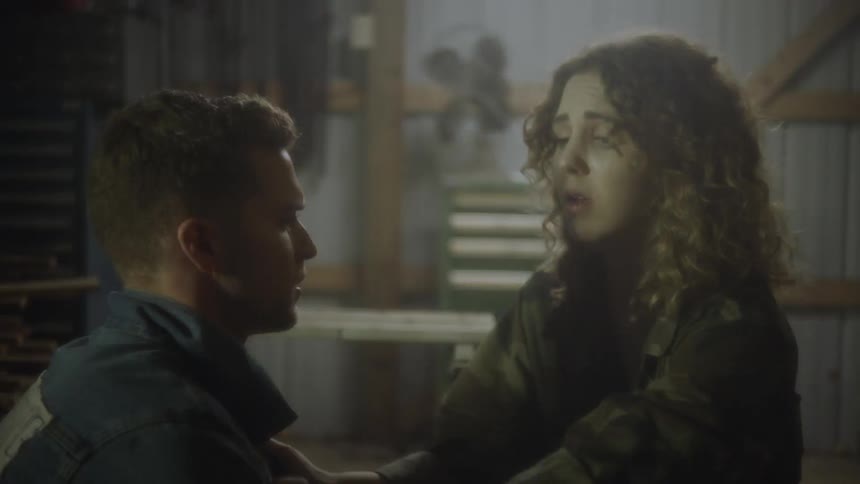 A scared woman breathing quickly while a man tries to hep