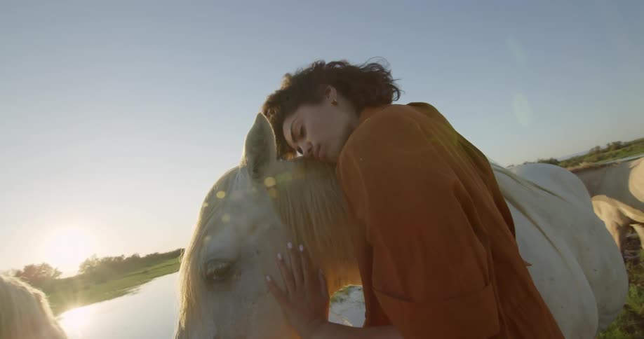 A woman is hugging her horse