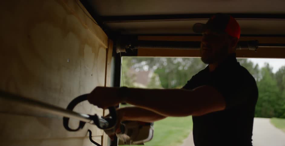A man is walking and grabbing a tool to use