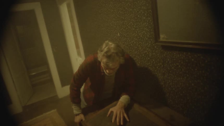 Old man stumbling through hallway in haunted house